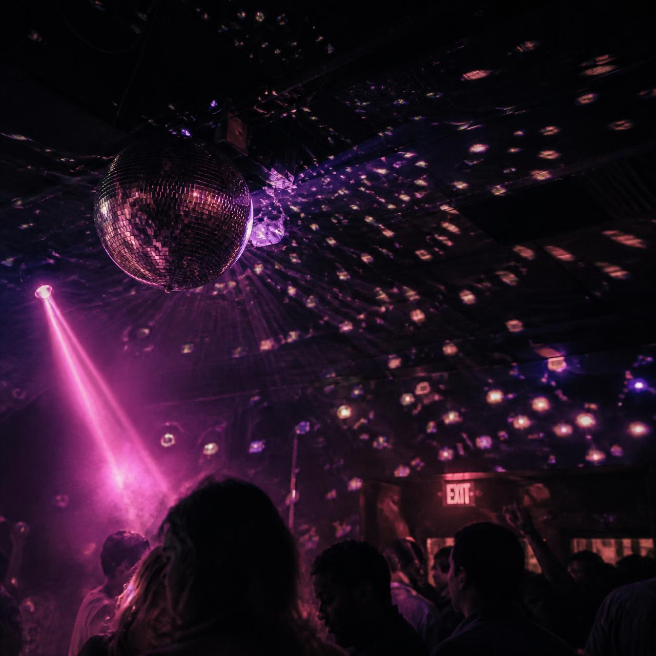 Mirror ball reflections across the club ceiling